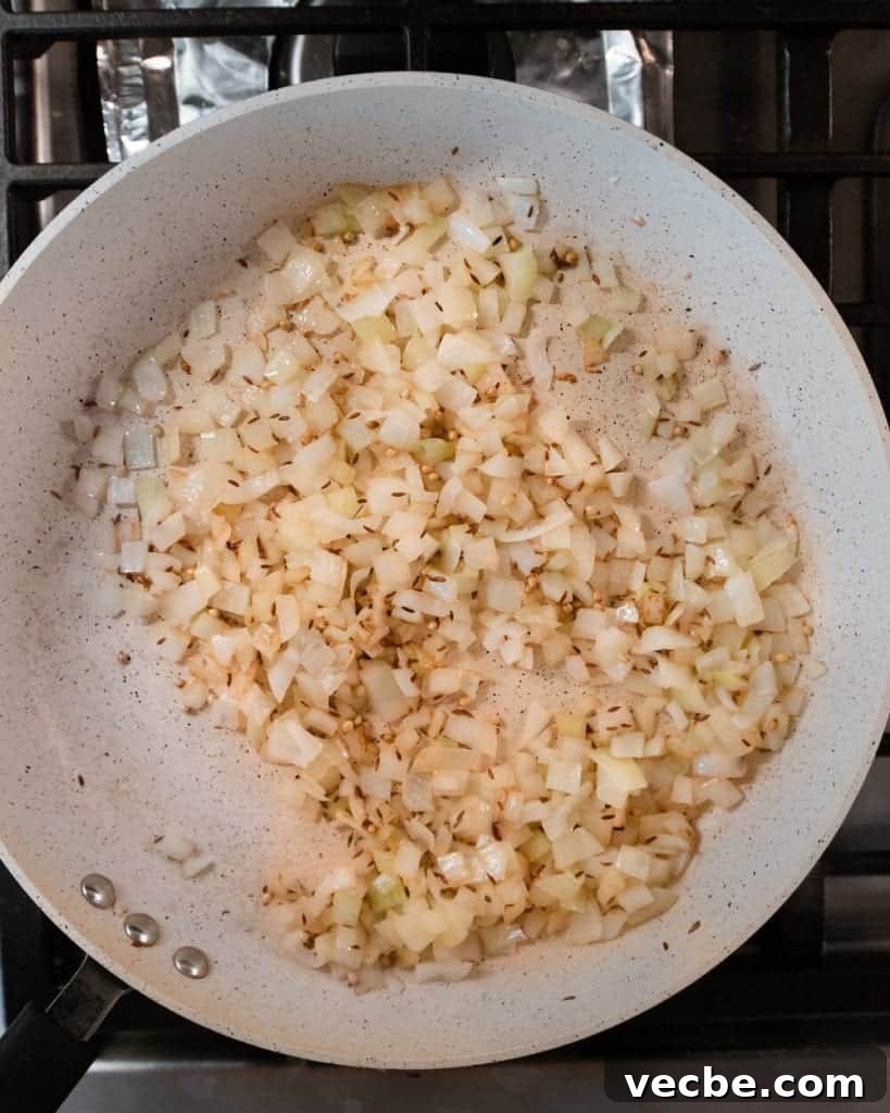 Creamy Vegan Pumpkin Curry with Crispy Tofu 14 onions sautéing in oil