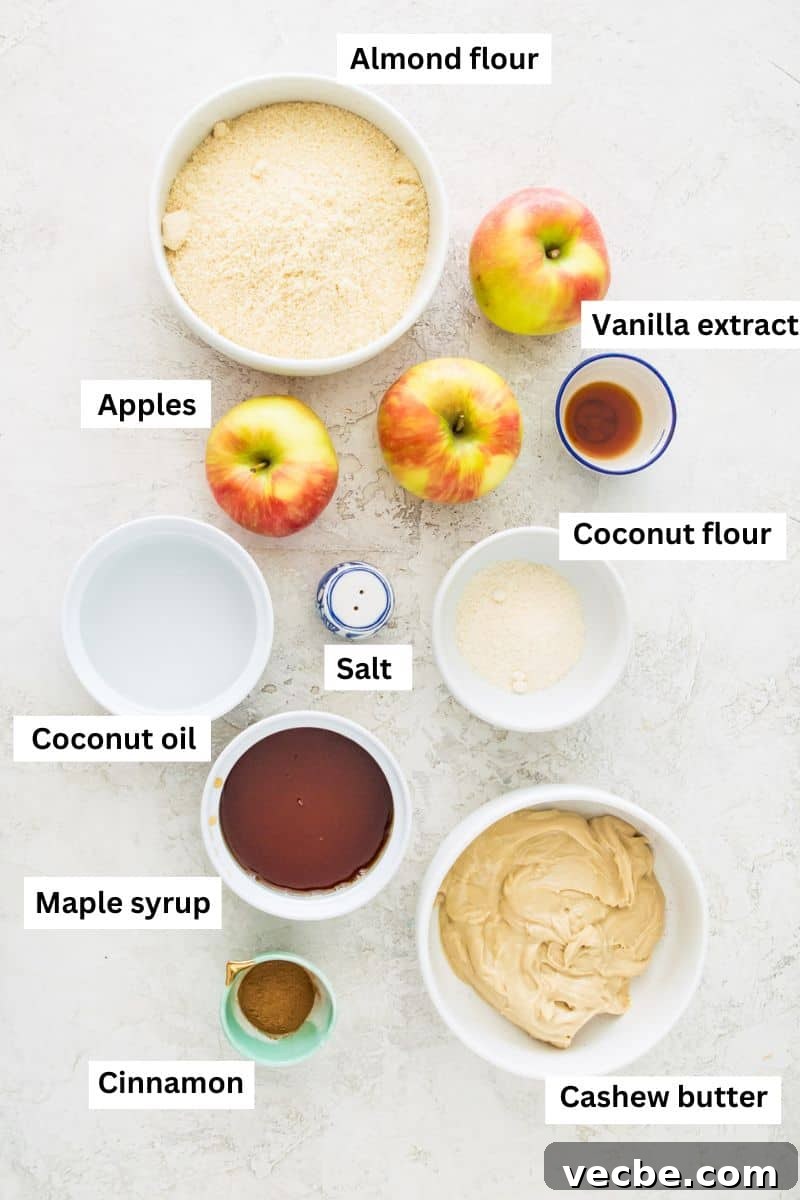 Apple Pie Bars Gluten Free Vegan and Paleo 3 The ingredients needed to make apple pie bars in bowls including almond flour, apples, maple syrup, coconut oil and vanilla extract.