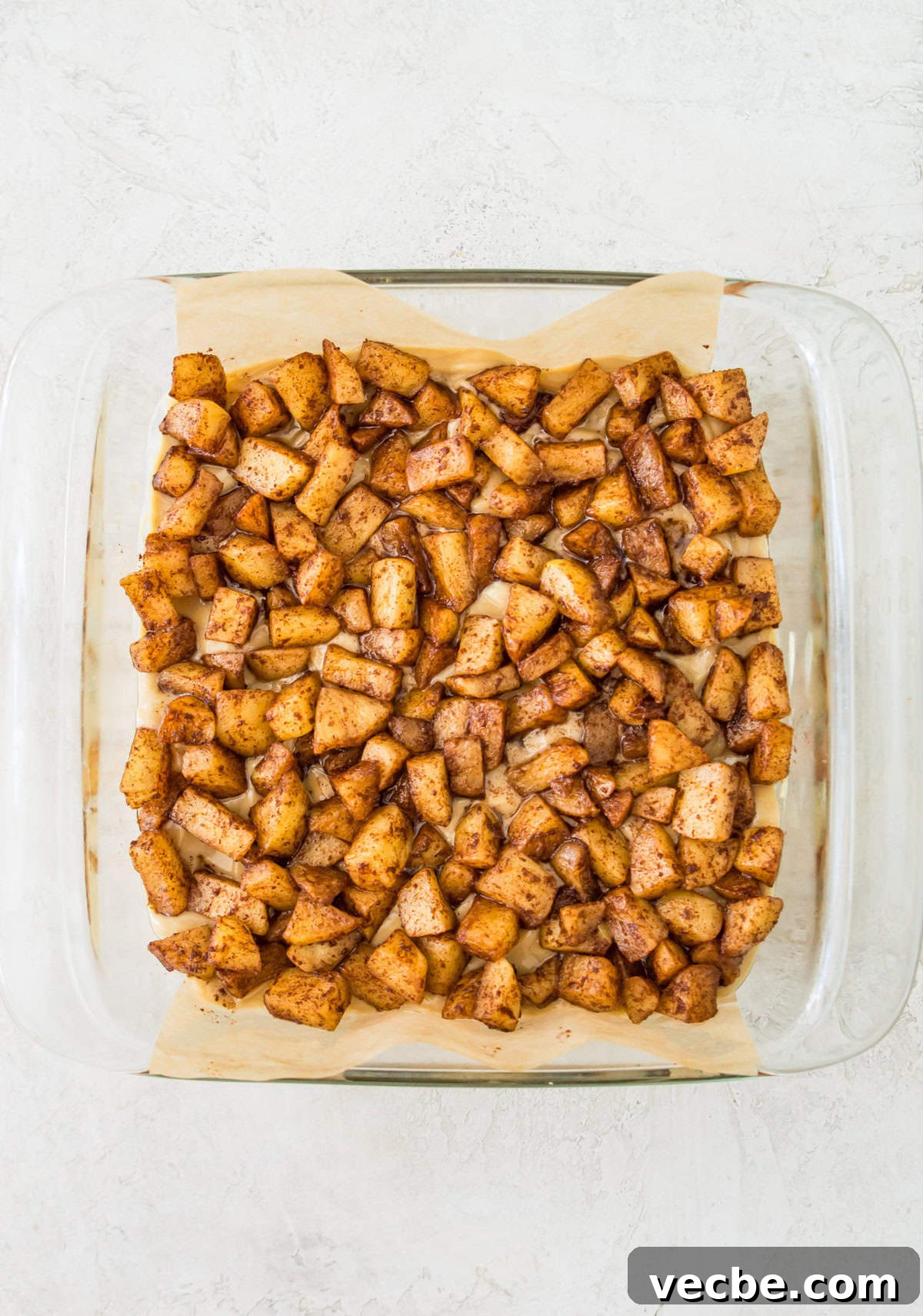 Apple Pie Bars Gluten Free Vegan and Paleo 9 A square baking pan with cooked apple pieces in it.