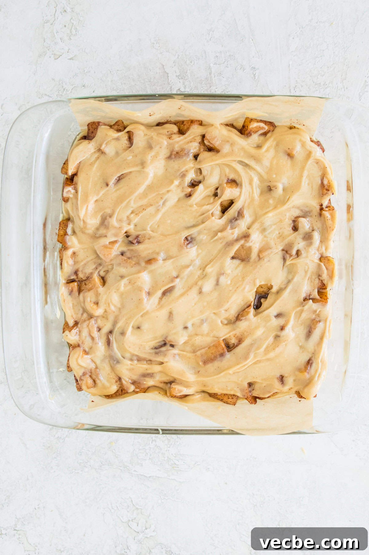 Apple Pie Bars Gluten Free Vegan and Paleo 10 A square baking pan with cooked apples topped with caramel in it.