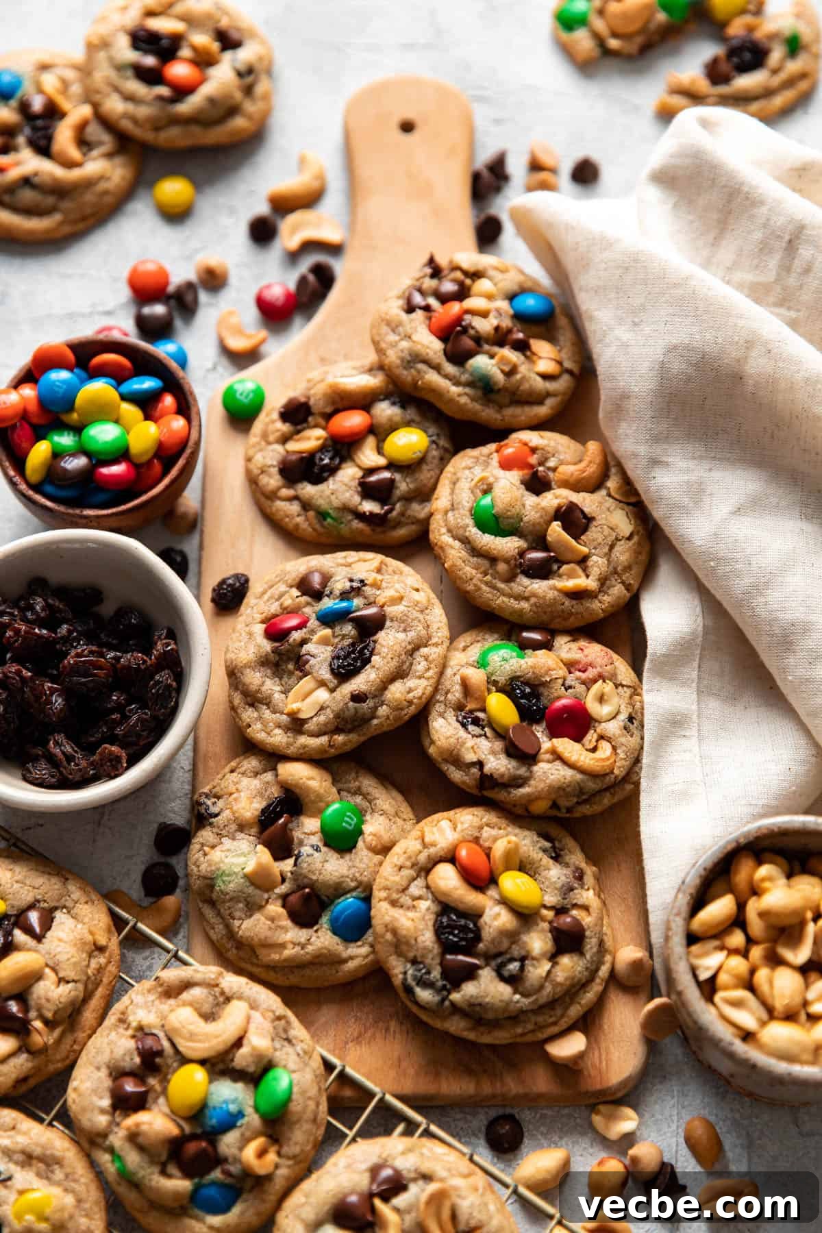 Trail Mix Cookies Recipe with Oats Nuts and Chocolate 2 trail mix cookies on a serving board.
