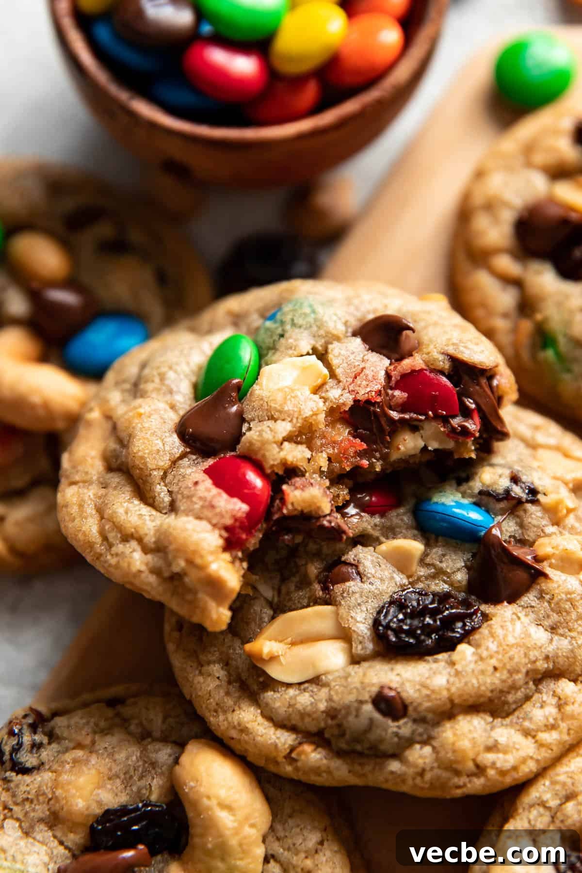 Trail Mix Cookies Recipe with Oats Nuts and Chocolate 3 bite taken out of a trail mix cookie.