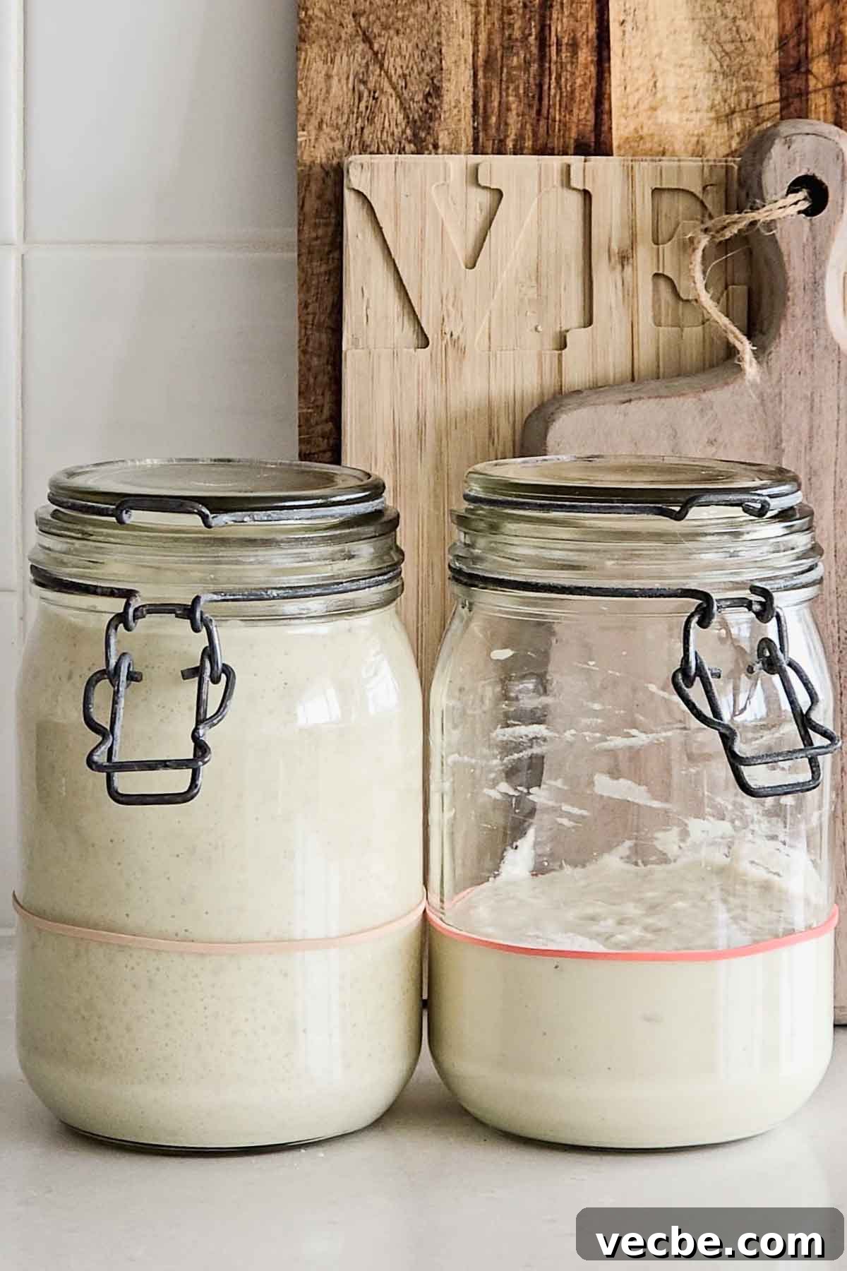 Why Your Sourdough Starter Is Weak and How to Revive It 3 Two jars of sourdough starter, first with a healthy, bubbly starter, second with a weak, thin, flat starter.
