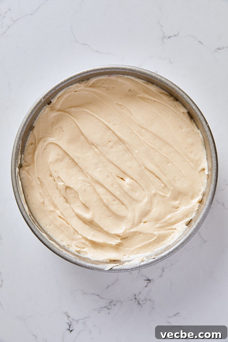 From-Scratch Peach Upside-Down Cake Recipe 7 Cake batter layered over peach slices in round cake pan