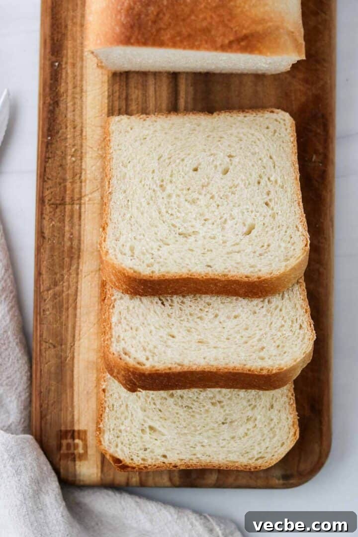 Homemade Soft and Tender Buttermilk Bread Recipe 11 Three slices of Soft and Tender Buttermilk Bread on cutting board.