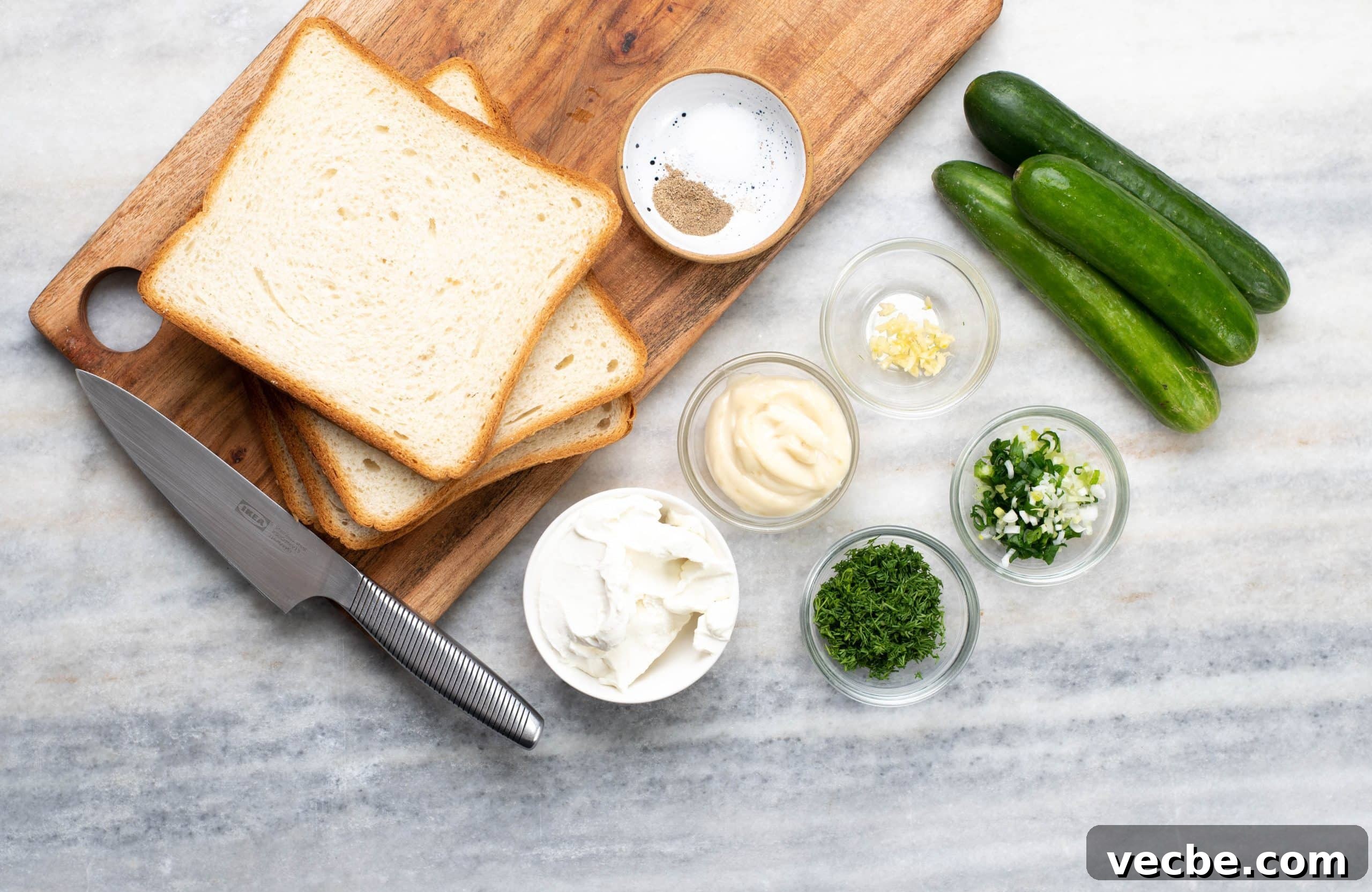 Ingredients for Cucumber Sandwiches Ingredients to make Tea cucumber sandwiches - Bread slices, cucumbers, cream, cheese, herbs and spices to make the spread.