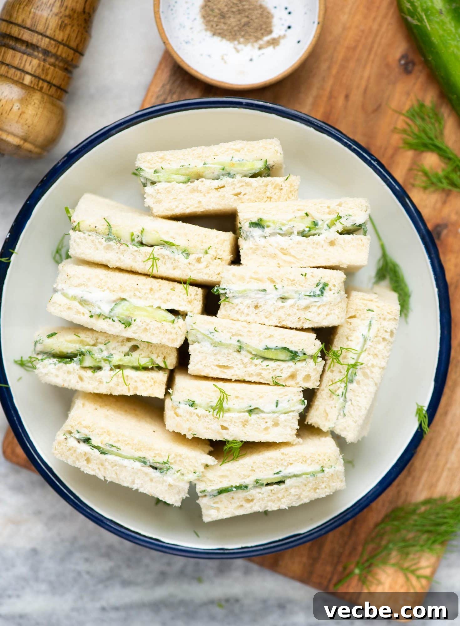 Cucumber Sandwiches Cucumber sandwiches cut into halves and arranged in a big plate.