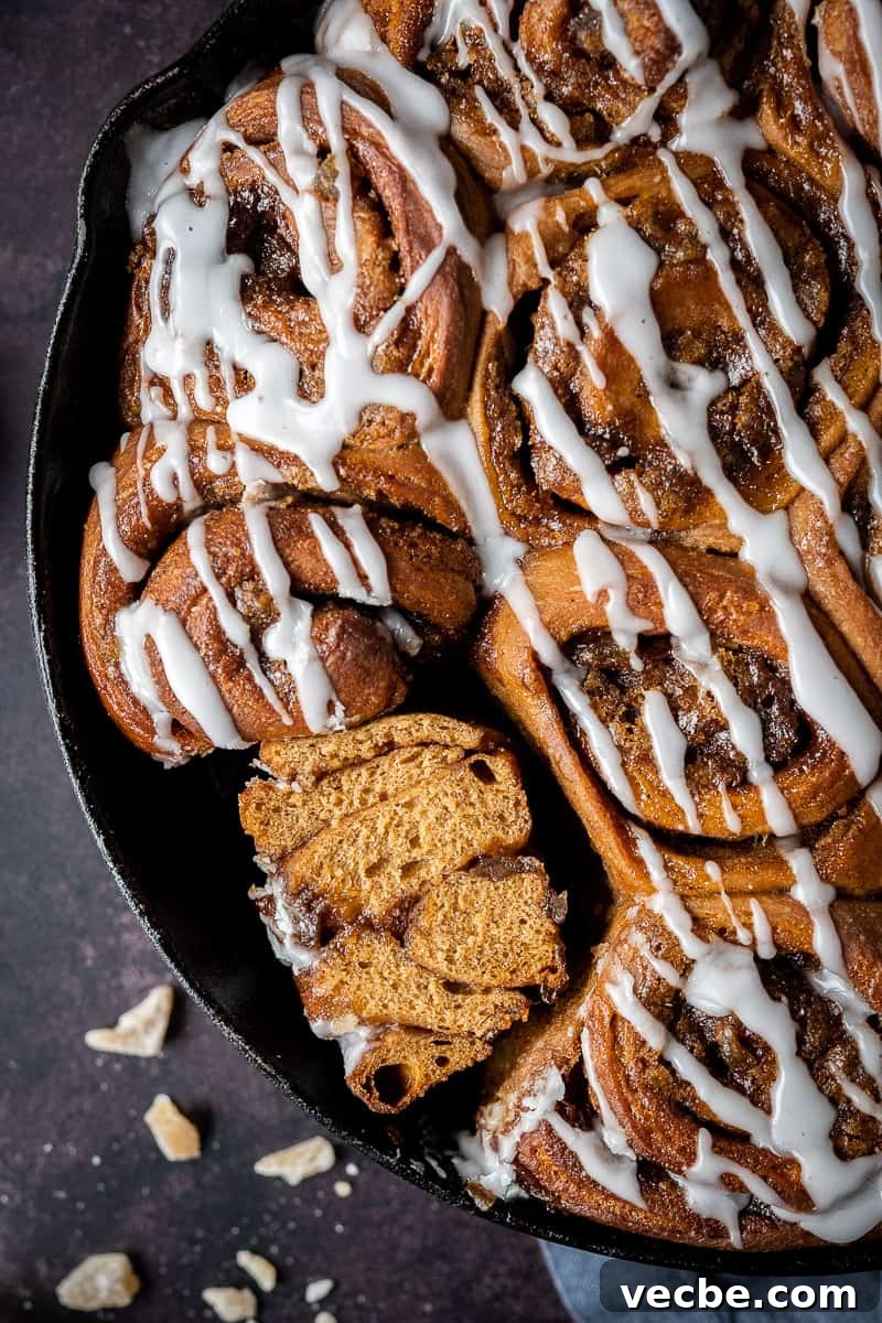 Close up of a sliced vegan gingerbread cinnamon roll close up of a ginger cinnamon roll sliced in half