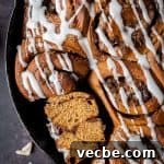 Vegan Gingerbread Cinnamon Rolls Recipe 9 close up of a ginger cinnamon roll sliced in half