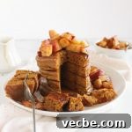 Stack of pumpkin spice protein pancakes with sauteed apples