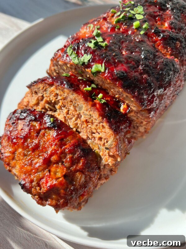 Caramelized Air Fryer Pineapple Recipe 5 Air Fryer Meatloaf sliced and topped with a glossy glaze, garnished with chopped herbs.
