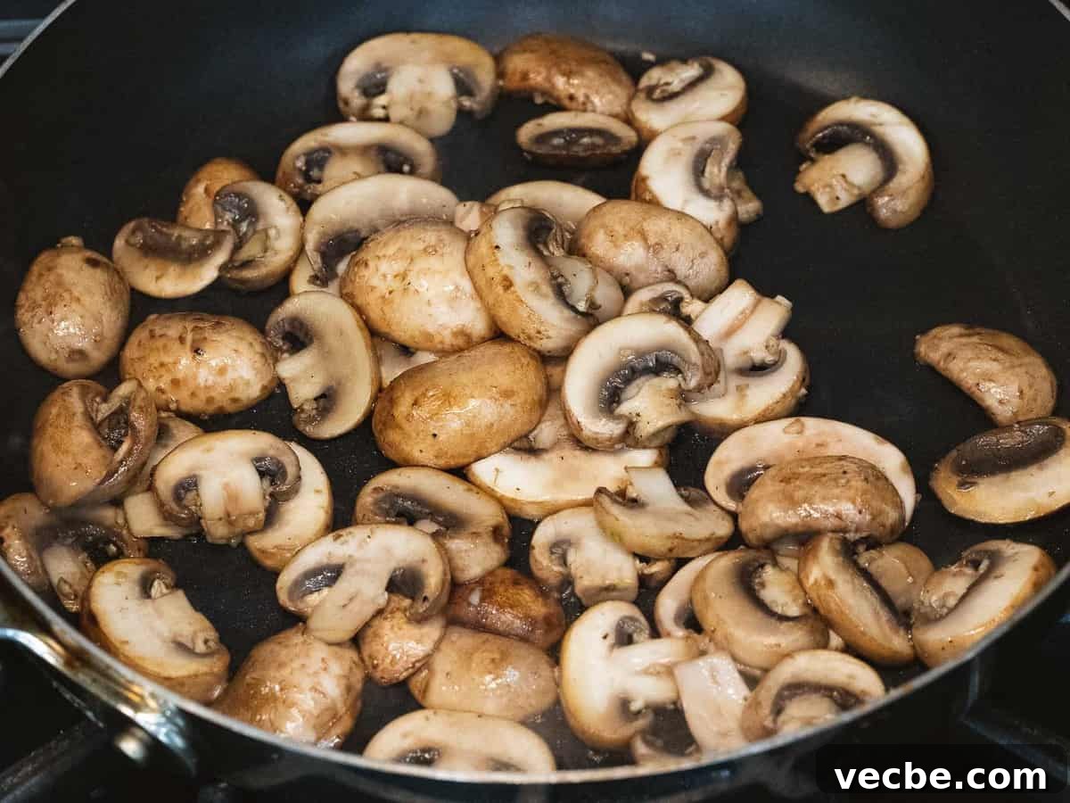 Homemade Mushroom Gravy Recipe for Roasts and Potatoes 4 Sautéed mushrooms in a pan.