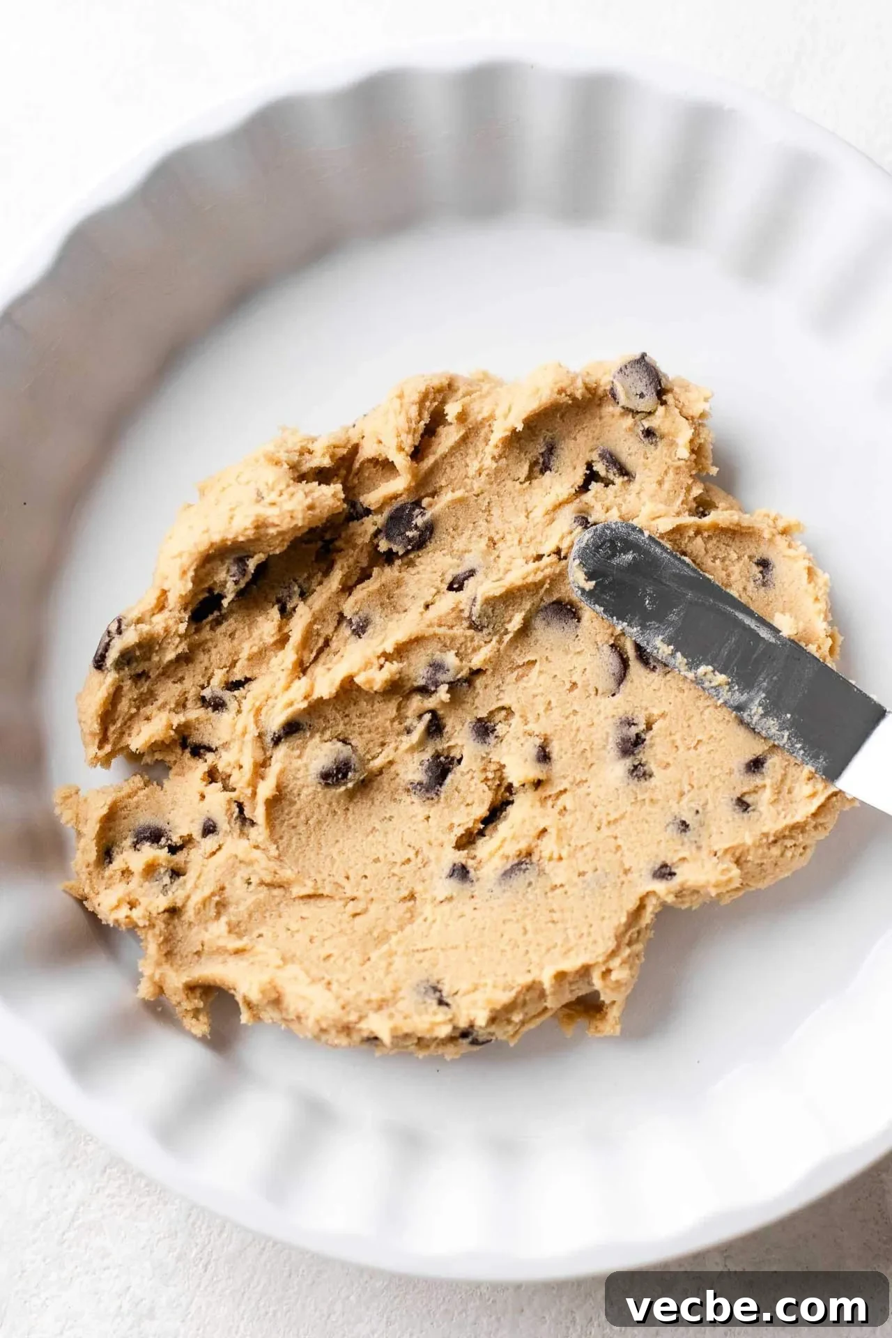 Giant Nutella-Stuffed Chocolate Chip Cookie Recipe 7 half of chocolate chip cookie dough spread into bottom of pie dish