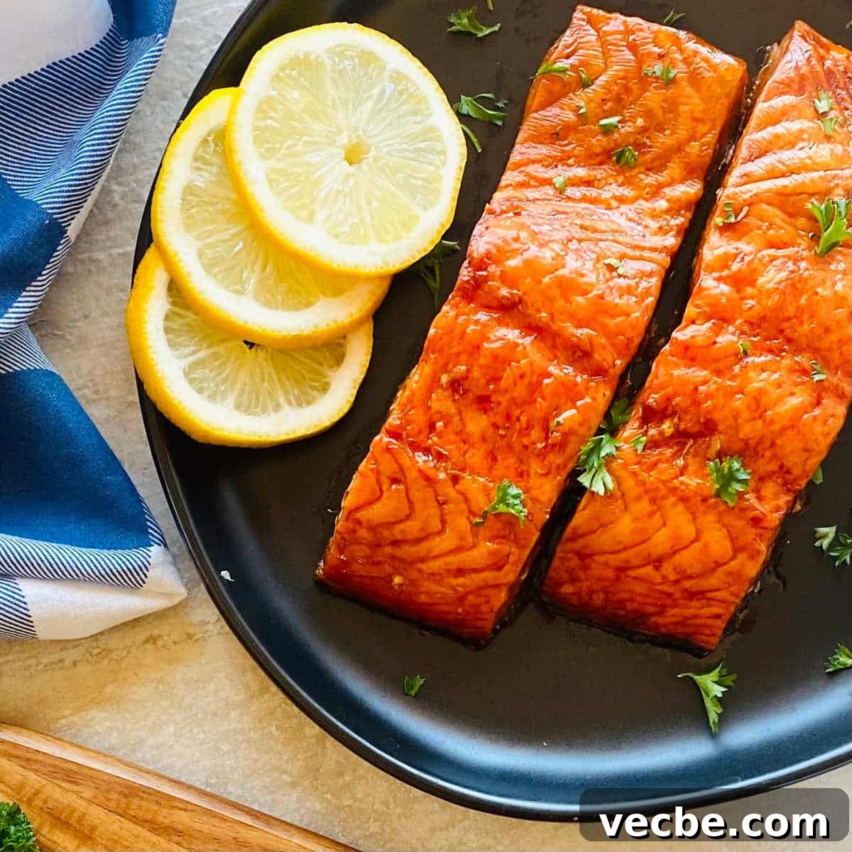 How to Smoke Salmon on a Traeger for Smoky, Flaky Results 5 pit boss smoked salmon on a plate with sliced lemons.