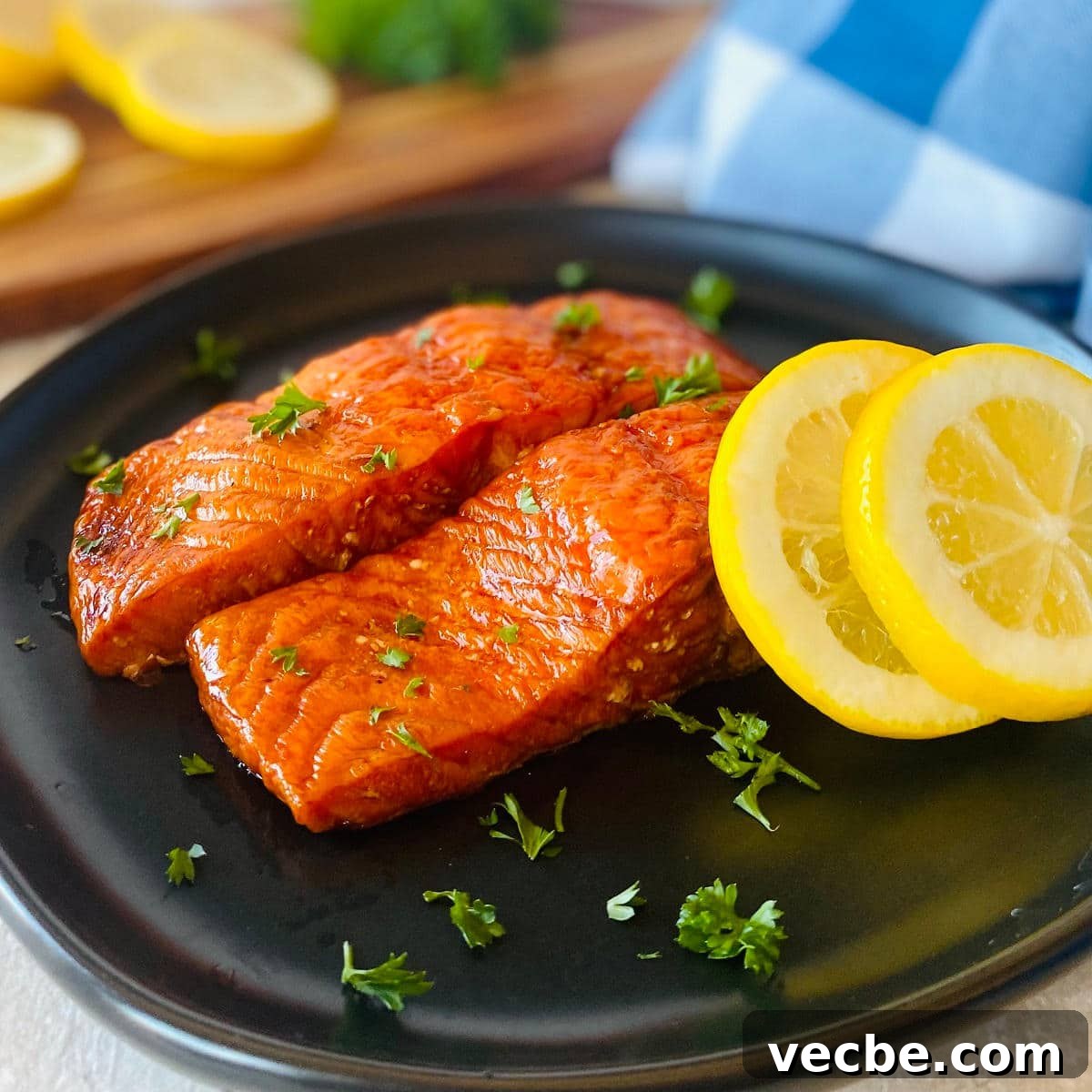 How to Smoke Salmon on a Traeger for Smoky, Flaky Results 6 smoked salmon on a plate with sliced lemons and parsley garnish.