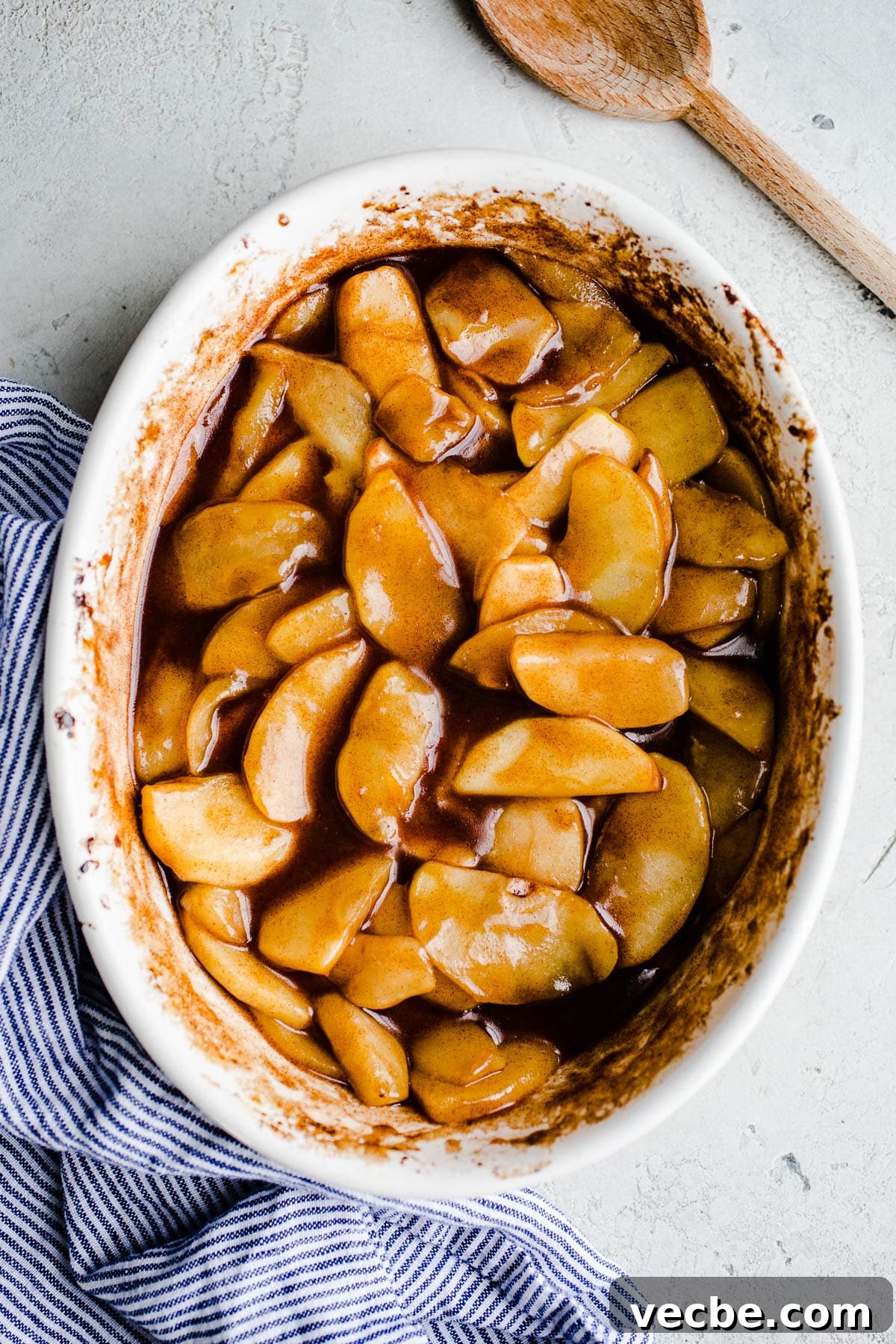 Gluten-Free Apple Recipes: 10+ Desserts, Snacks and More 13 Cinnamon baked apples in a white baking dish.