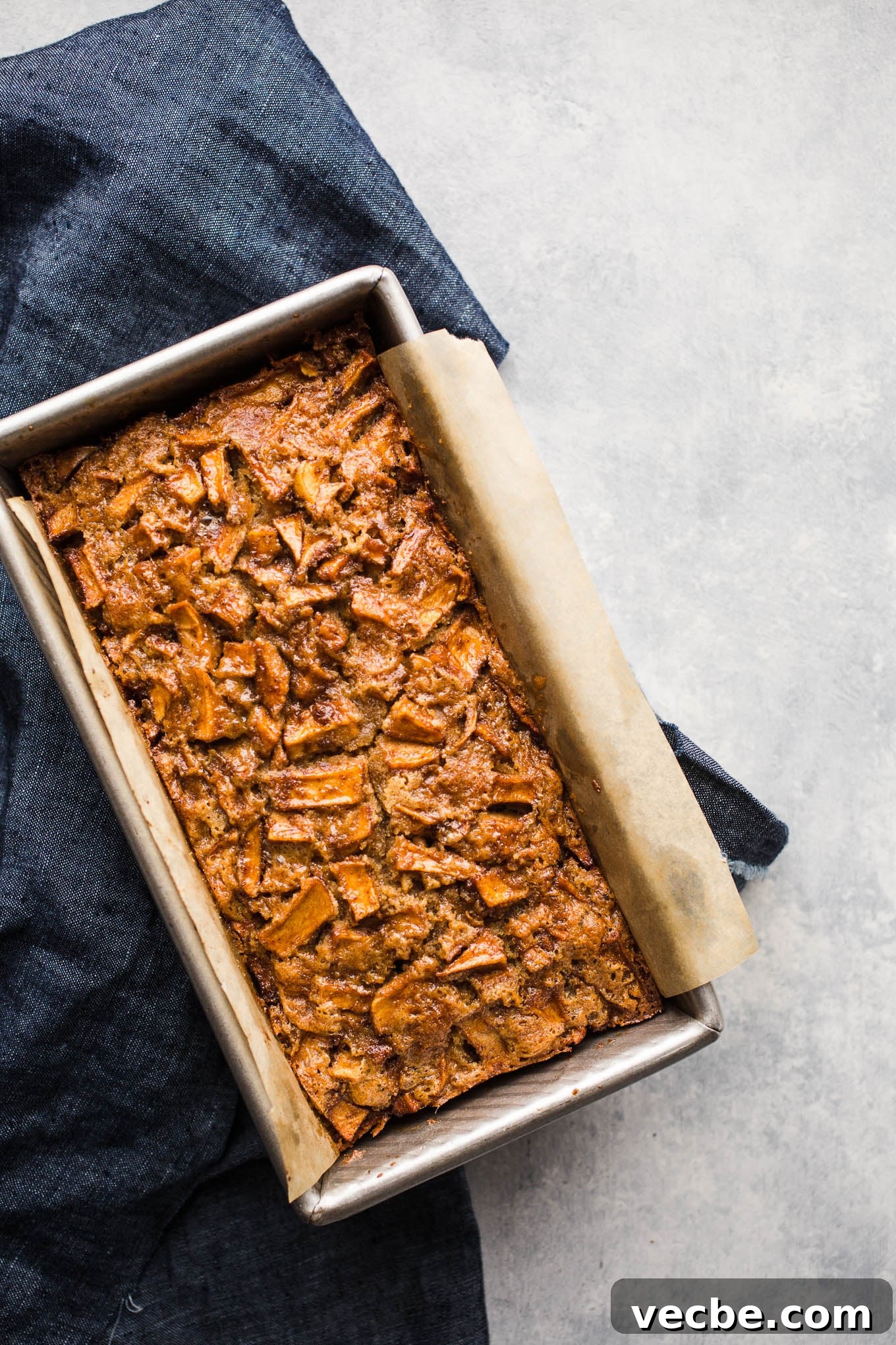 Gluten-Free Apple Recipes: 10+ Desserts, Snacks and More 5 Apple cake on a piece of parchment paper.