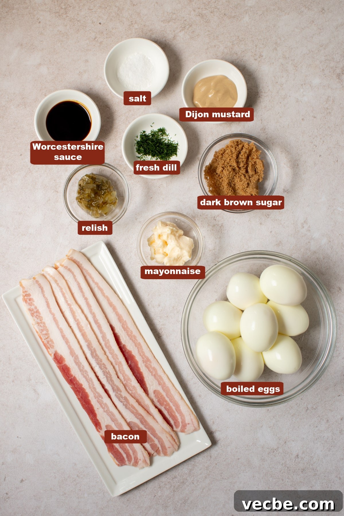 Crispy Candied Bacon Deviled Eggs 2 All of the ingredients for deviled eggs with candied bacon in bowls or plates on a countertop.