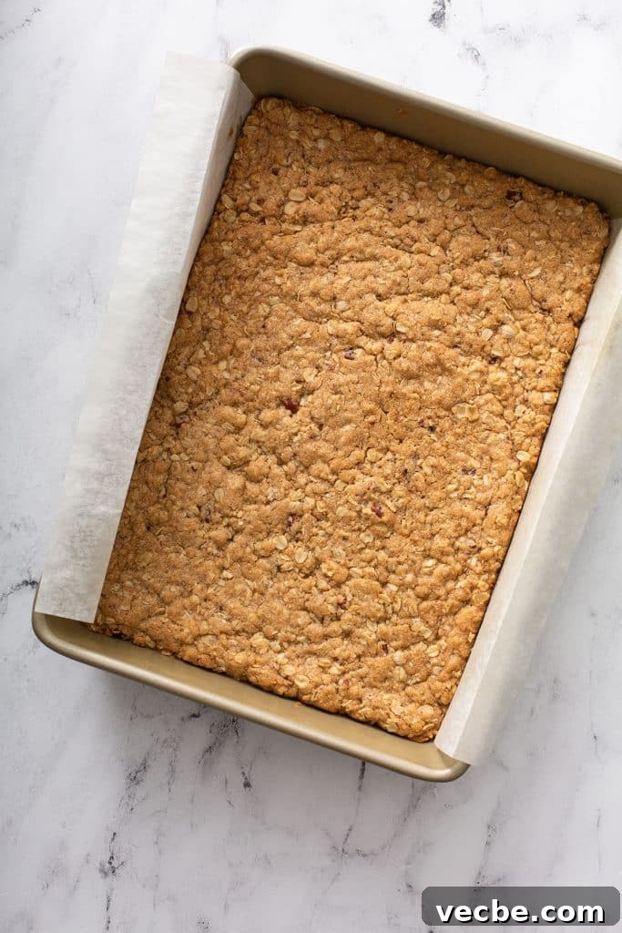 Pumpkin Cheesecake Bars with Creamy Swirl 9 Baked oat crust in a baking pan.