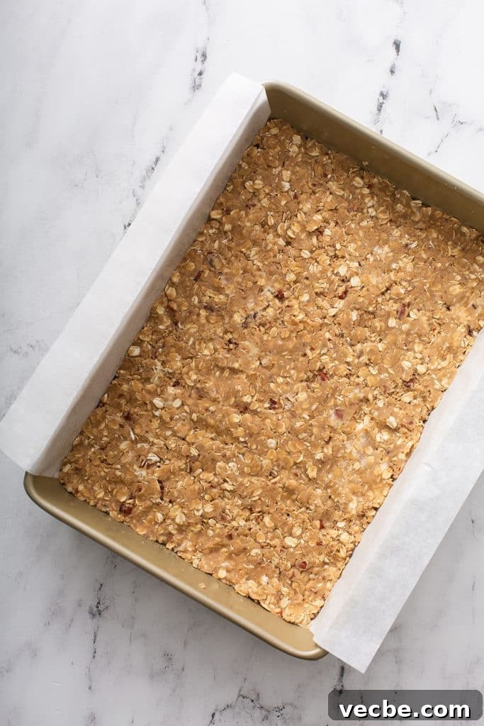 Pumpkin Cheesecake Bars with Creamy Swirl 8 Unbaked oat crust pressed into a baking pan.
