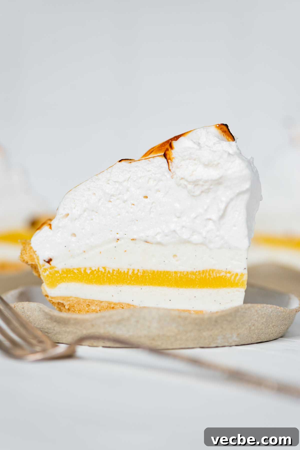 Lemon Meringue Ice Cream Pie Recipe 3 Slices of lemon meringue ice cream pie on dessert plates from BeyondtheButter.com | © Beyond the Butter®