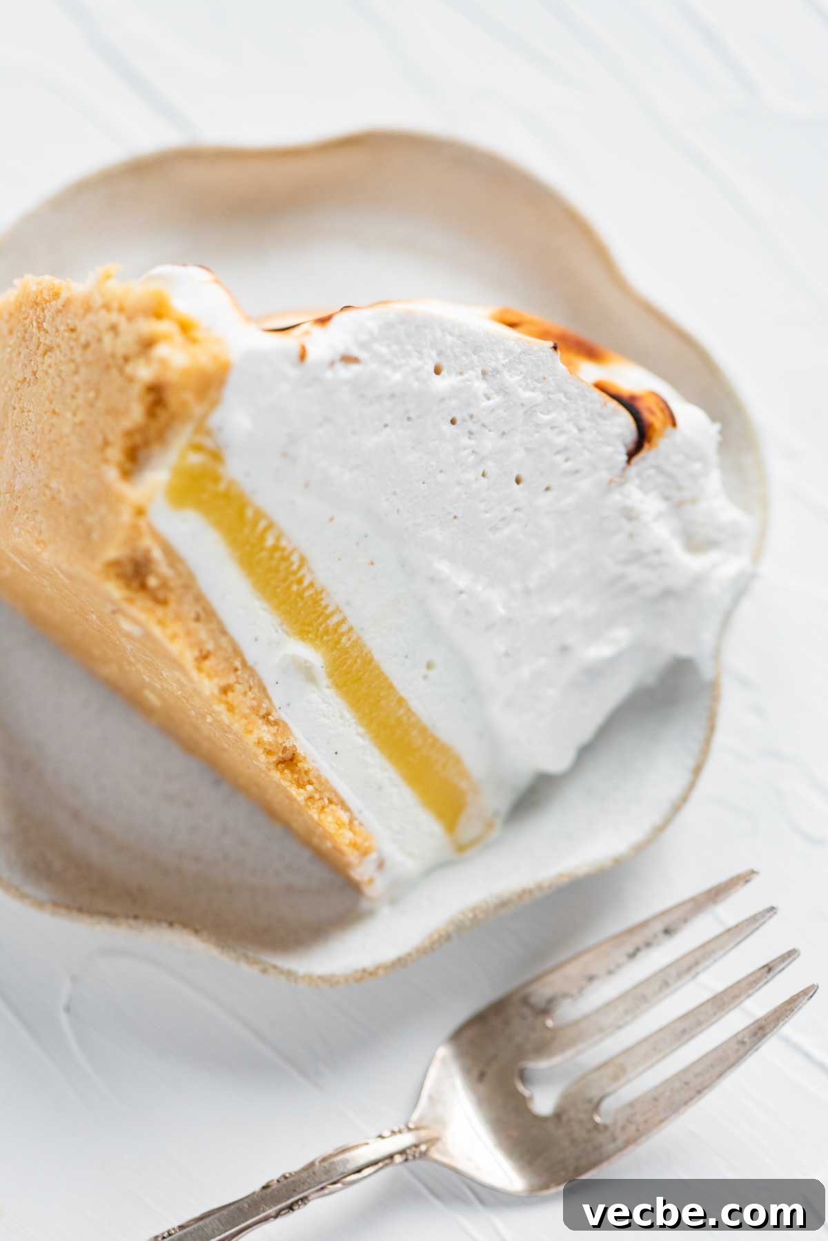 Lemon Meringue Ice Cream Pie Recipe 4 Slice of lemon meringue ice cream pie on its side from BeyondtheButter.com | © Beyond the Butter®