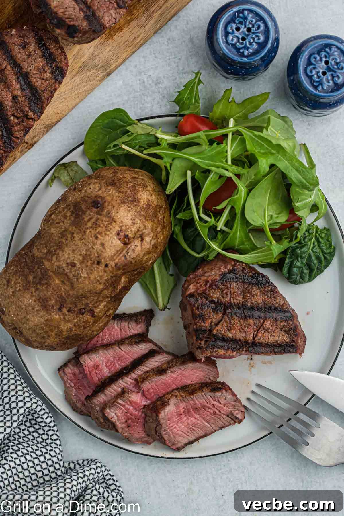 Grilled Filet Mignon Recipe: Tender, Juicy Steak 6 Filet Mignon on a plate with baked potato and salad