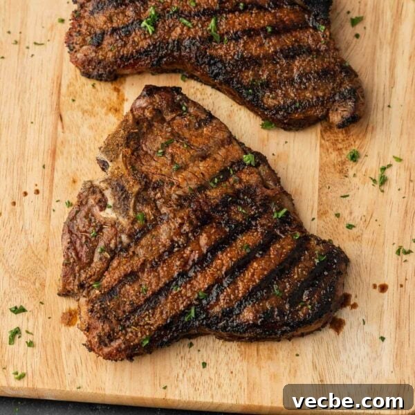 Grilled Filet Mignon Recipe: Tender, Juicy Steak 8 Two steaks on a cutting board with herbs.