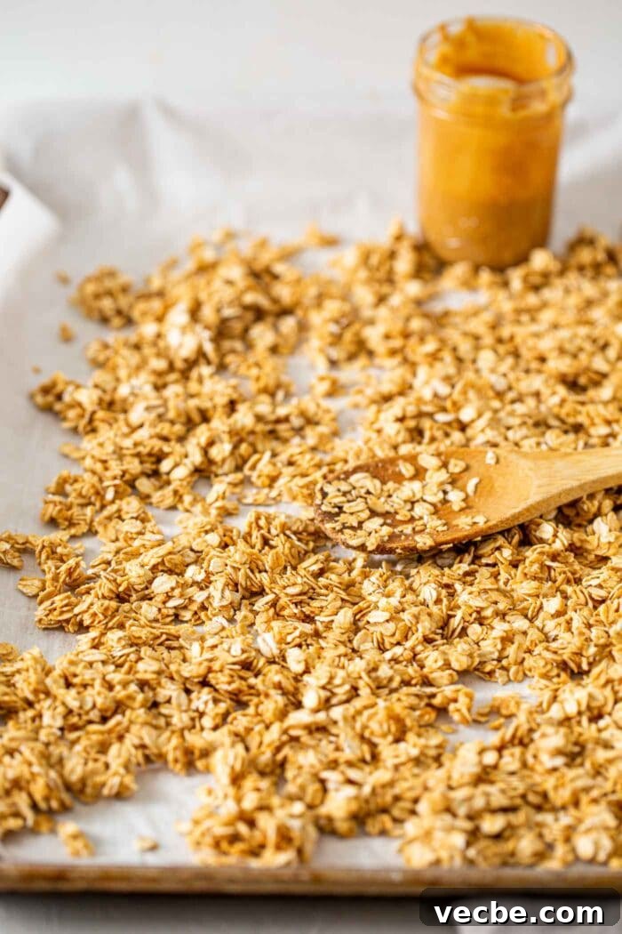 Homemade Peanut Butter Granola Recipe 5 Peanut butter granola spread on a baking tray.