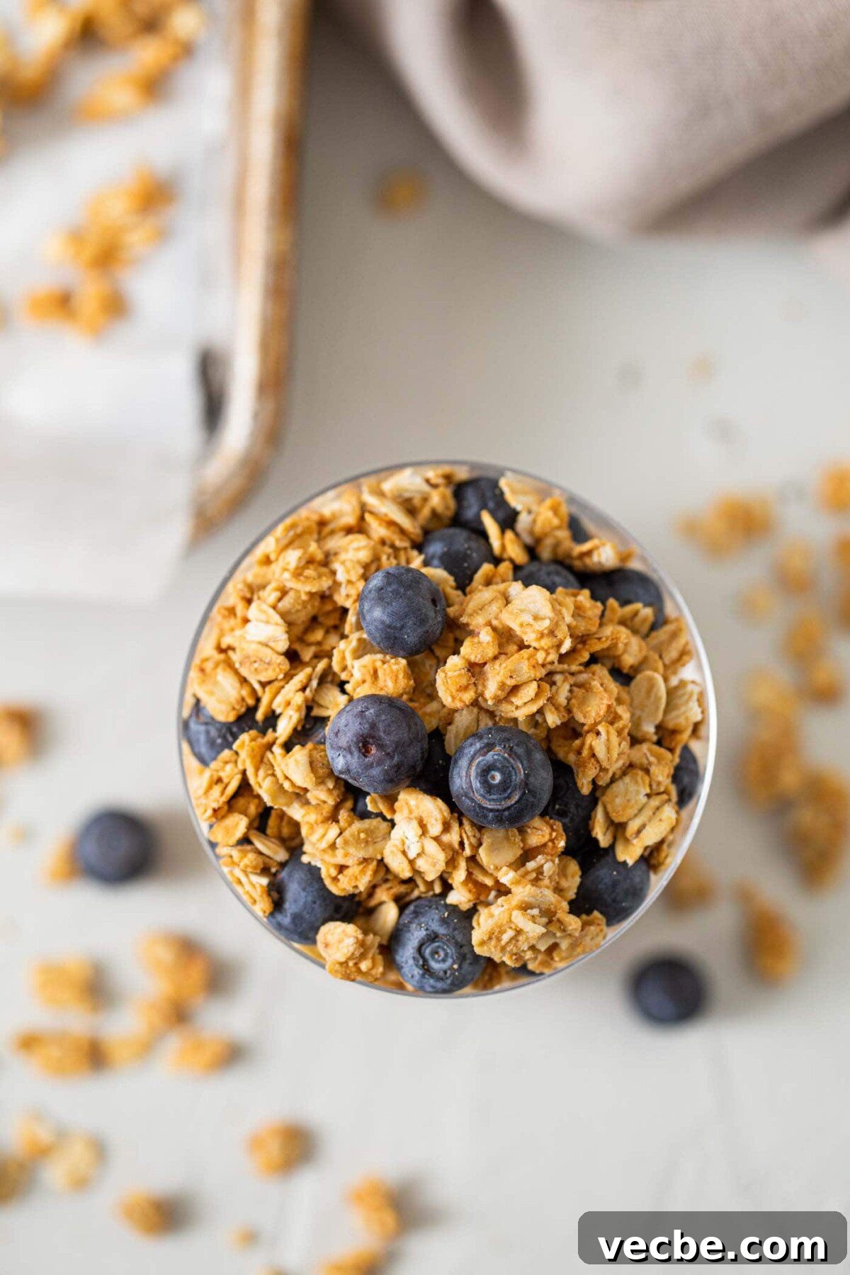 Homemade Peanut Butter Granola Recipe 6 Granola topped with blueberries in a glass jar.