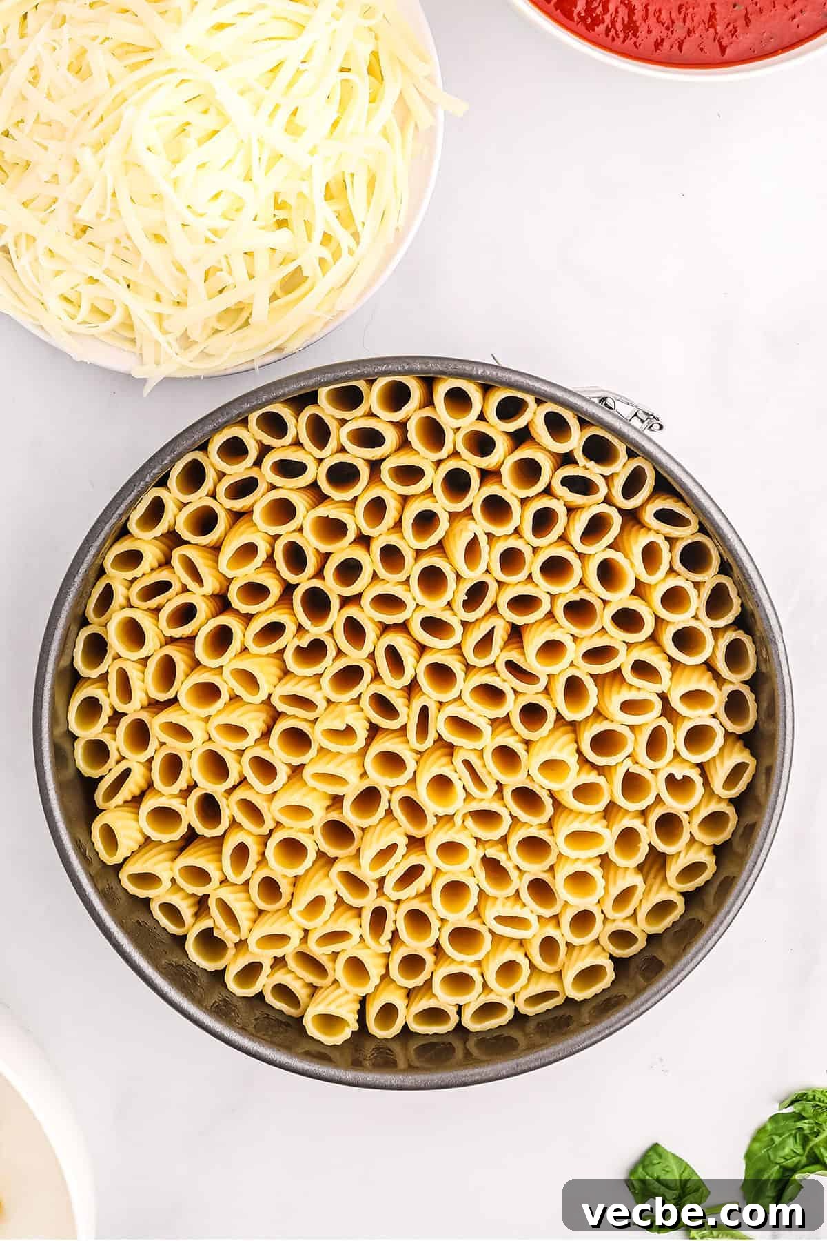 Rigatoni arranged in a springform pan for honeycomb pasta rigatoni noodles standing upright in a springform pan