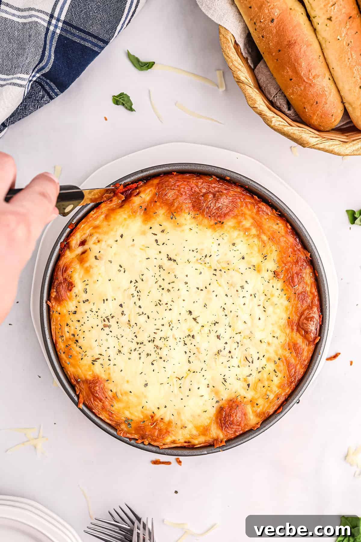 Slicing baked rigatoni pie slicing honeycomb pasta in a springform pan