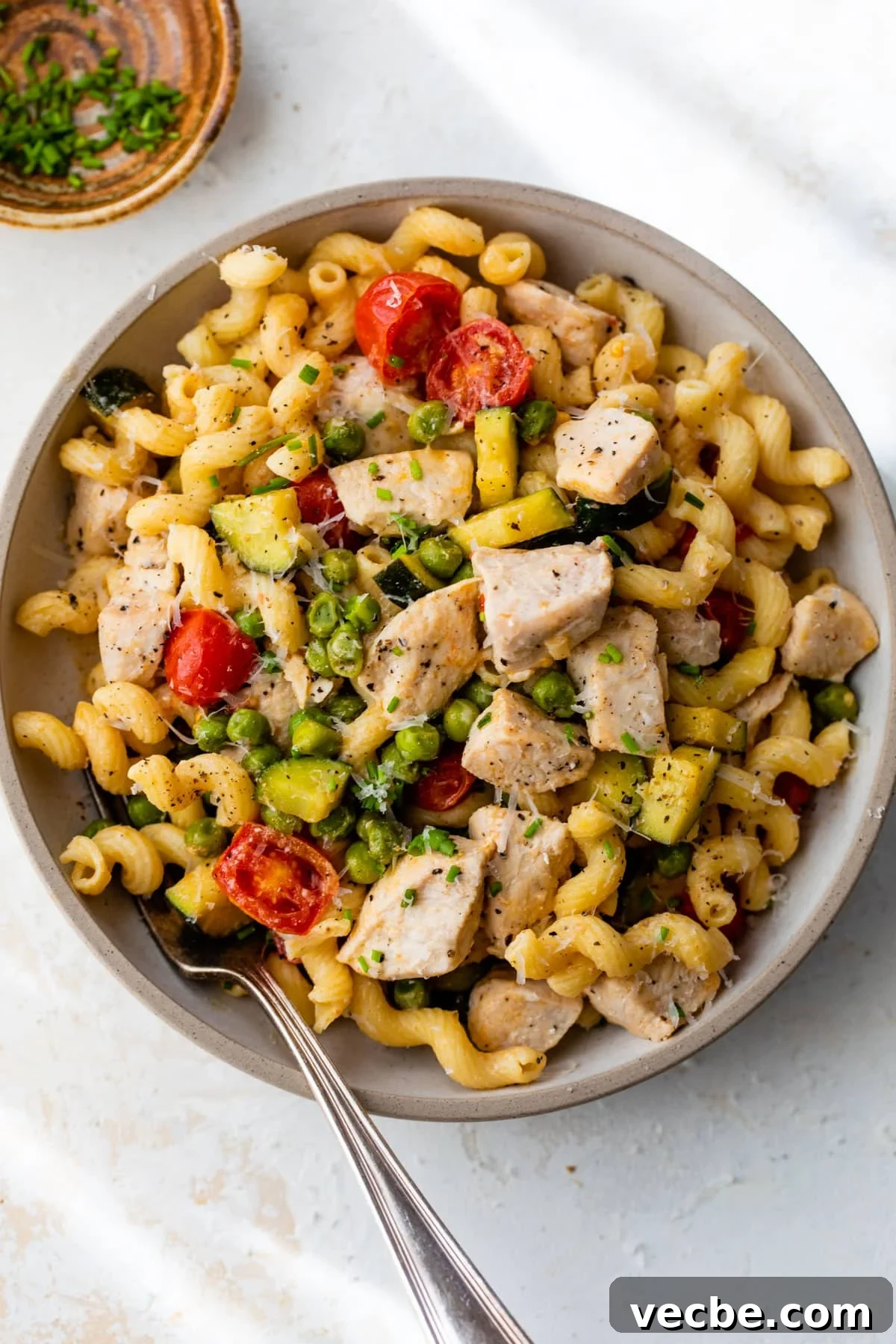 Chicken Pasta Primavera with Fresh Spring Vegetables 5 chicken pasta primavera in a bowl with a fork
