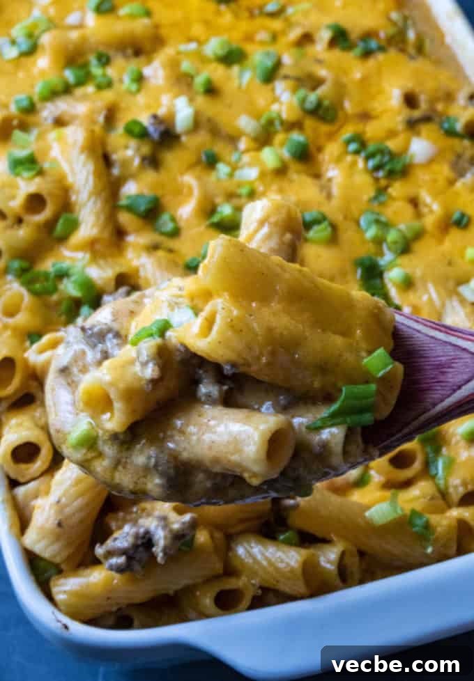 Cheesy Beef Taco Pasta Bake Recipe 3 taco pasta on a serving spoon
