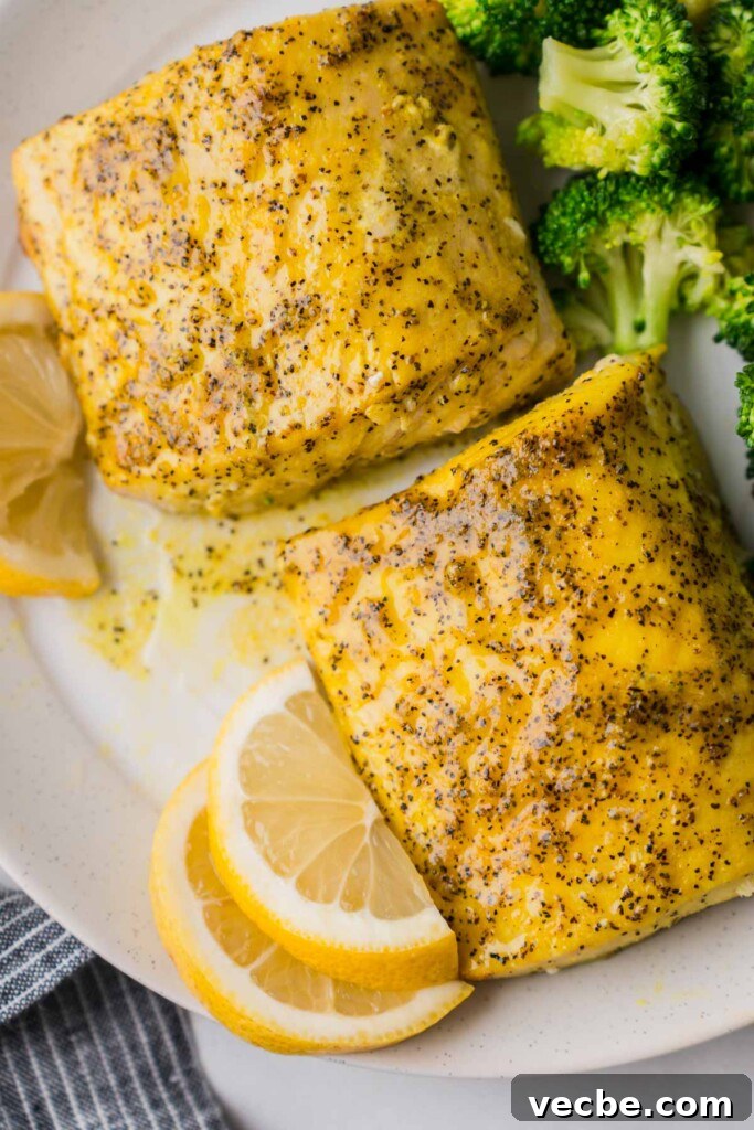 Air Fryer Mahi Mahi with Lemon Garlic 9 cooked mahi mahi on a plate with broccoli.