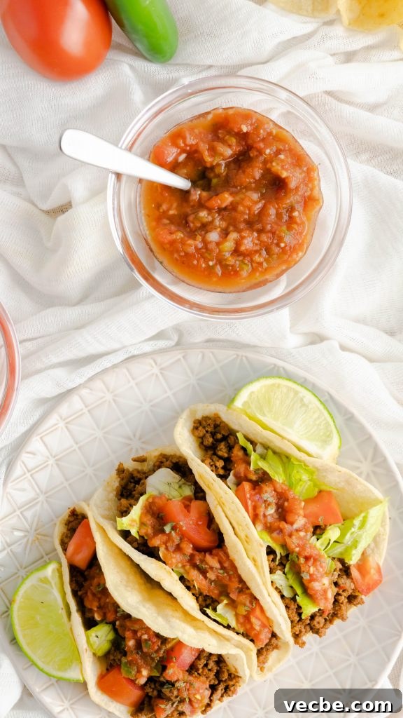 Restaurant-Style Ground Beef Tacos Recipe 2 Restaurant-style ground beef tacos on corn tortillas and fresh ingredients.