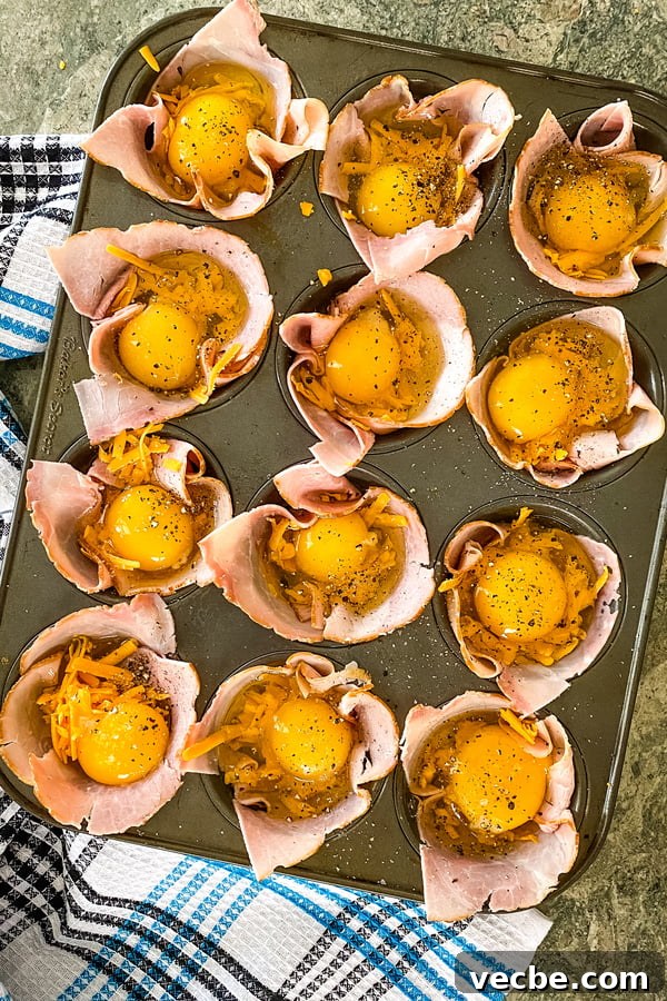 Ham and Egg Breakfast Cups Recipe 4 ham and egg cups ready to go in the oven