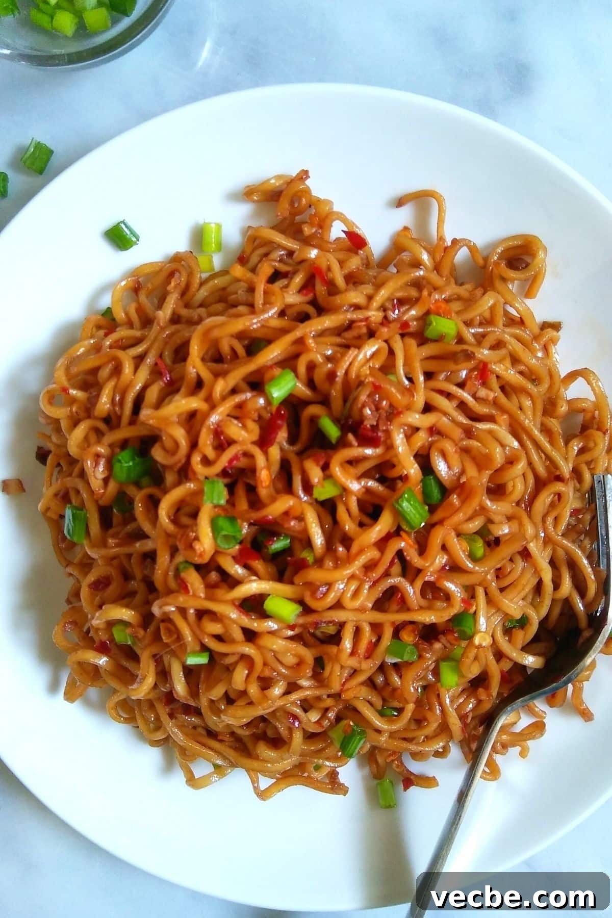 10-Minute Spicy Ramen Recipe 2 Ramen noodles served on a white plate.