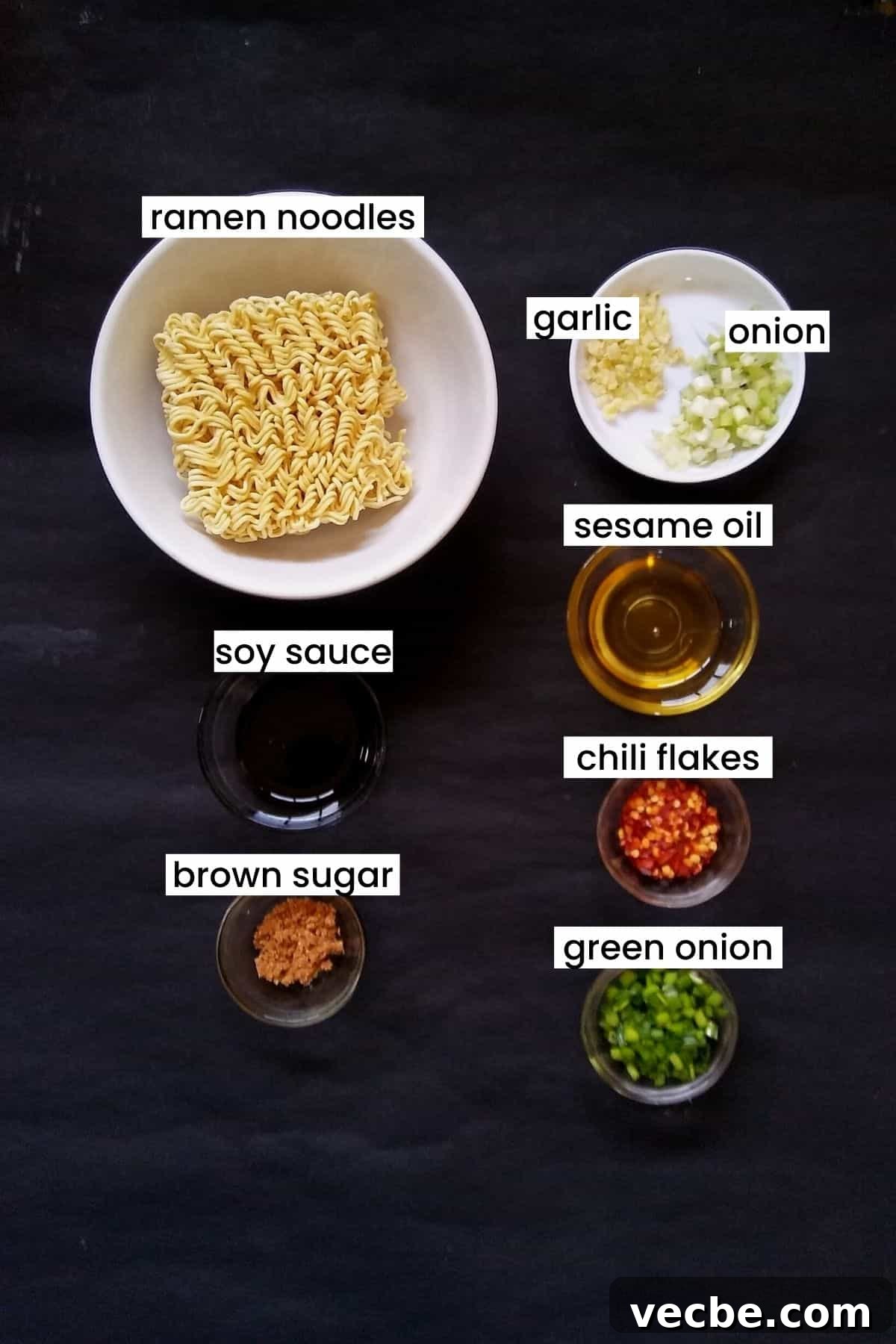 10-Minute Spicy Ramen Recipe 3 Spicy ramen noodles ingredients on a black background.