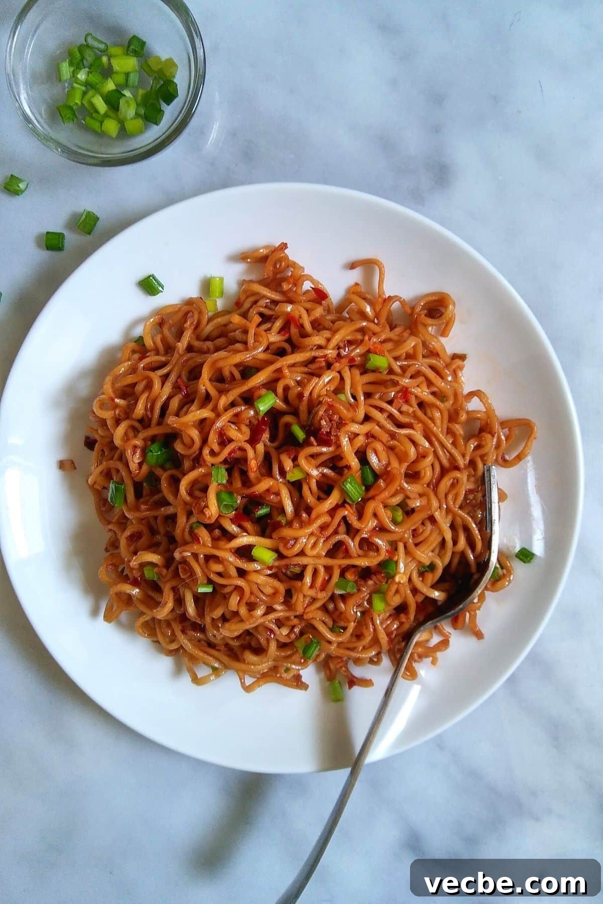 10-Minute Spicy Ramen Recipe 5 Ramen noodles on a white plate.