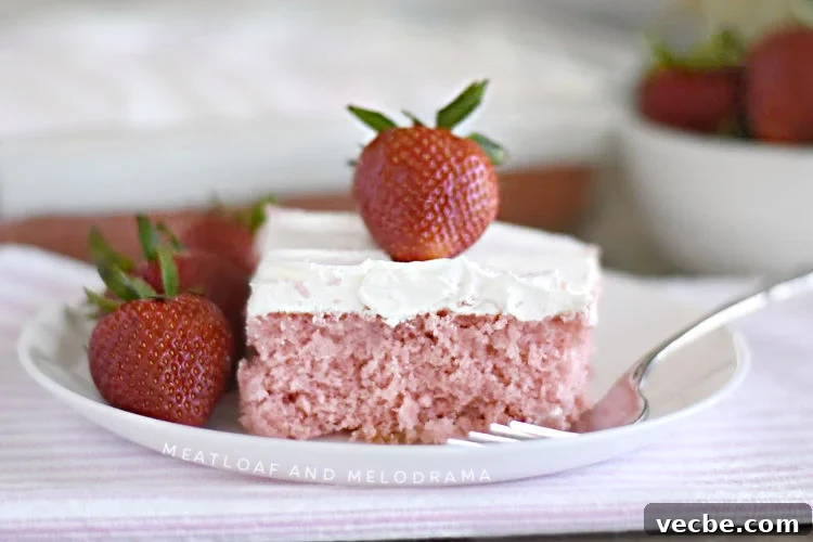 Homemade Strawberry Cream Soda Cake Recipe 2 strawberry cream soda cake with whipped topping and strawberry on white plate