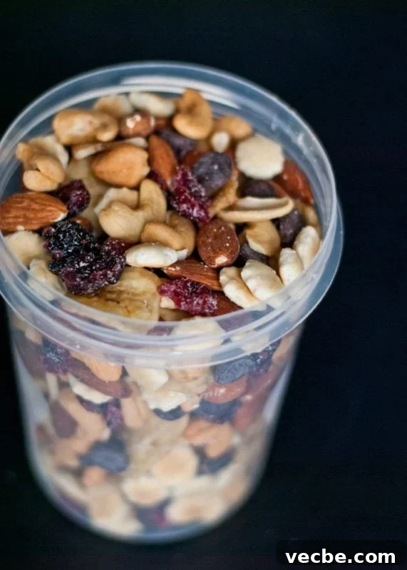 15 No-Bake Snack Recipes You Can Make in Minutes 14 a glass filled with a mix of nuts and raisins