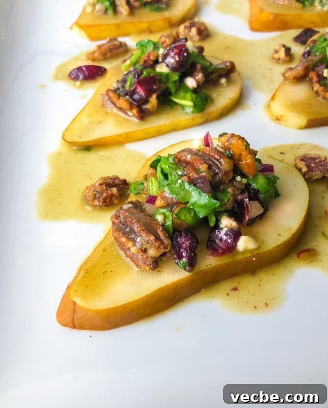 15 No-Bake Snack Recipes You Can Make in Minutes 15 A no bake recipe of sliced pear with pecans, craisins and dressing on white plate.