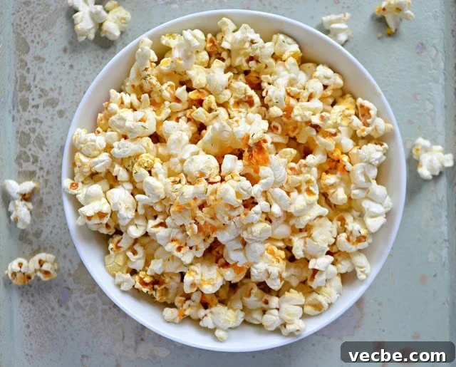 15 No-Bake Snack Recipes You Can Make in Minutes 17 Buffalo ranch seasoned popcorn in a white bowl.