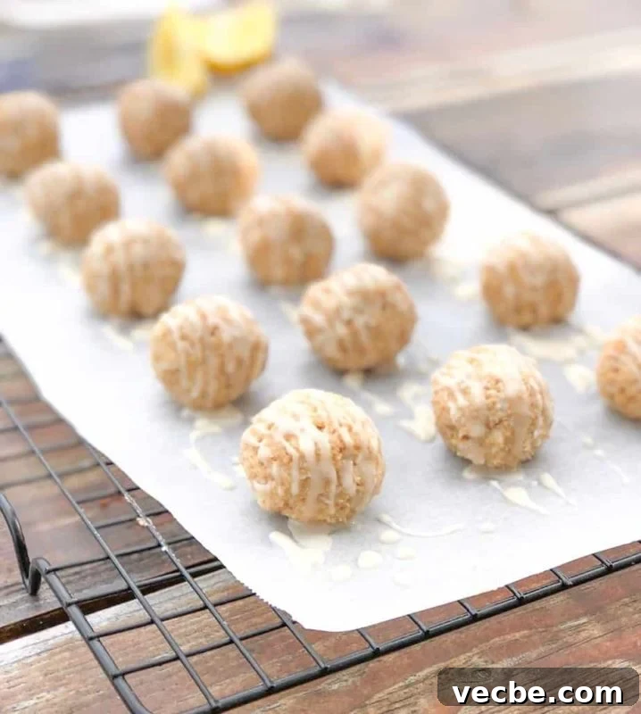 15 No-Bake Snack Recipes You Can Make in Minutes 5 Cheesecake truffles on parchment paper over wire rack with lemon.