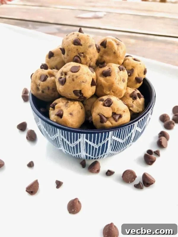 15 No-Bake Snack Recipes You Can Make in Minutes 7 Cookie dough balls with chocolate chips in a bowl.