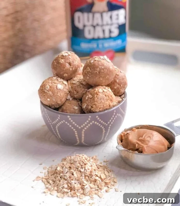 15 No-Bake Snack Recipes You Can Make in Minutes 9 Peanut butter energy balls with oatmeal on table and a measuring cup filling with peanut butter.