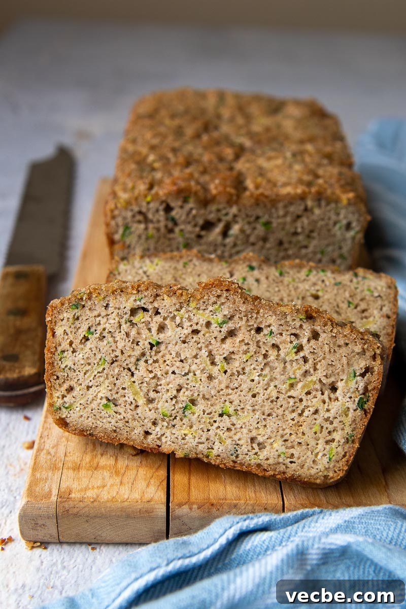 Gluten-Free Almond Flour Zucchini Bread: Secret Moist Recipe 2 a slice of almond flour zucchini bread sliced and propped up against the loaf