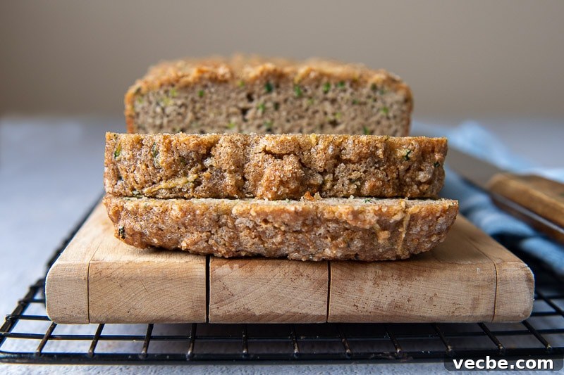 Gluten-Free Almond Flour Zucchini Bread: Secret Moist Recipe 7 slices of bread on a wooden cutting board with the top facing the camera