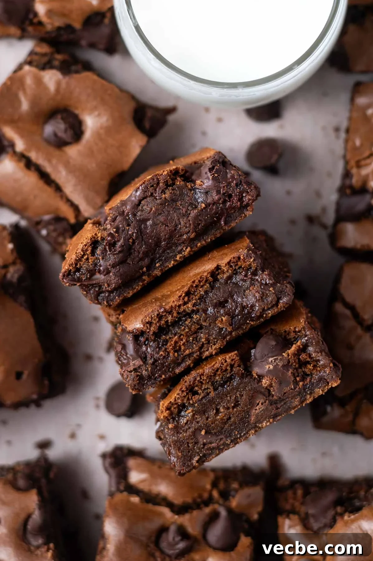 One-Bowl Double Chocolate Chip Bars 2 glass of milk with double chocolate cookie bars showing fudgy and soft centers
